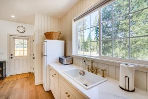 a kitchen with a white refrigerator and a sink at Modern Studio in Bend about 3 Mi to Sunriver Resort! in Bend