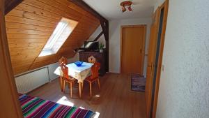 a dining room with a table and two chairs at Haus Waldschänke in Erlbach