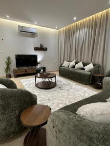 a living room with two couches and a television at الماجدية 53 ( A3) in Riyadh