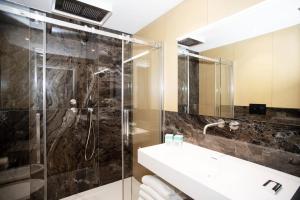 a bathroom with a glass shower and a sink at Hotel Barcarola 2 in Marina di Campo