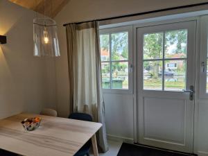 a dining room with a table and a large window at Fenix Edam in Edam