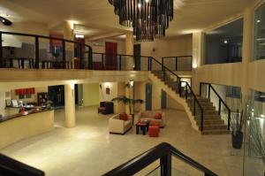 a large lobby with a staircase in a building at Kohylia by La Scala Beach in Limenas