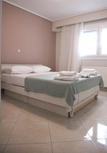 a bedroom with a bed with towels on it at Sea Front Retreat in Kavala