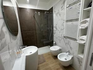 a bathroom with a sink and a toilet and a shower at MB HOME -Piano terra- in Bologna +23 photos
