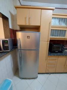 a stainless steel refrigerator in a kitchen with cabinets at شقق سكنيه للايجار in Cairo