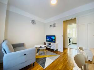 a living room with a couch and a table at Cozy Appart' 2 Centre ville proche gare Massy - Cozy Houses in Massy