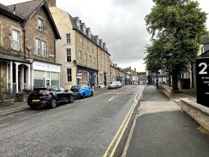 a city street with cars parked on the side of the road at Suze's Stays in Harrogate