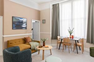 a living room with a couch and a table at SACO Bristol West India House in Bristol