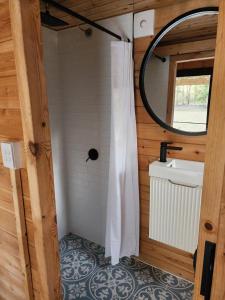 a bathroom with a shower curtain and a sink at Country Creek Cabin in Bromfleet
