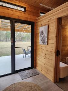 a room with a sliding glass door and a patio at Country Creek Cabin in Bromfleet