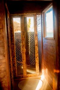 an open window in a wooden room with a door at PALM CULTURAL VILLAGE in Paje