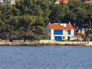 a house on the shore of a body of water at Villas Violet & Rosemary in Supetar