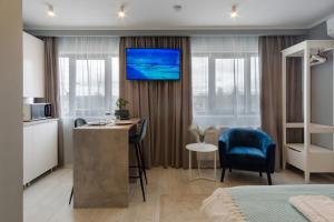 a hotel room with a bed and a desk and a tv at Premium Studio in Onesti in Onești +13 photos