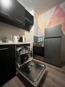 a kitchen with an empty dish rack in a dishwasher at Apartman Sasha 2 in Belgrade