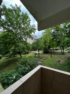 a balcony with a view of a park with trees at Apartman Sasha 2 in Belgrade