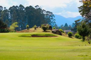 a view of a golf course with a green at Casa Blanca Hostal in Rionegro