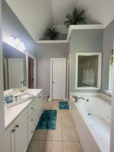 a large bathroom with two sinks and a tub and a tub at The Relaxation Getaway in Savannah