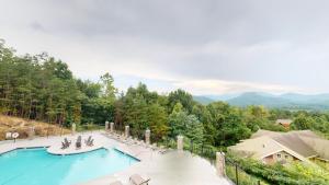 an outdoor swimming pool with chairs at Viewpoint Condominiums in Pigeon Forge