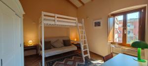 a small room with a bunk bed and a couch at Karales Antica Dimora in Cagliari
