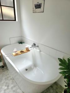 uma banheira branca com uma torneira na casa de banho em Studio 9 on Lakewood em Wellington