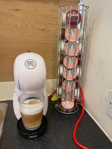 a coffee maker sitting on a counter with a cup of coffee at Comfy 2 Bedroom Flat near Edinburgh City Center in Edinburgh