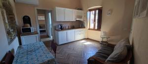 a living room with a couch and a kitchen at Karales Antica Dimora in Cagliari +26 photos