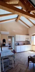 a kitchen with white cabinets and a table in a room at Karales Antica Dimora in Cagliari