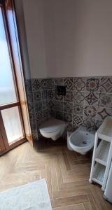 a bathroom with a sink and a toilet at Karales Antica Dimora in Cagliari