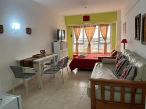 a living room with a couch and a table at DEPARTAMENTO PLAYA MIRAMAR in Miramar