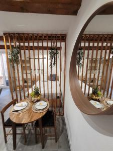 a dining room with a table and a mirror at Au cœur du citron in Menton