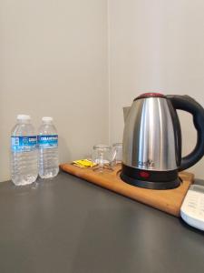 a tea kettle and two bottles of water on a counter at Ore Pera Suites in Istanbul