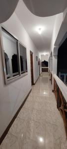 a hallway with a long corridor with windows and a hallwayngth at Aquarium Beach House in Nungwi