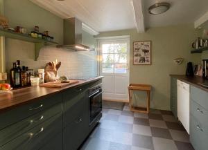 a kitchen with a counter and a window in it at Staevnegaarden in Flødstrup