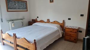 ein Schlafzimmer mit einem Holzbett und einem Nachttisch in der Unterkunft Casa centrale parcheggio gratis in Porto San Giorgio