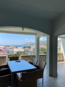 a table and chairs on a balcony with a view at Apartments Vila Kurtagic in Dobra Voda