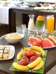 a table with two plates of fruit on it at Becar Pyramids B&B in Visoko