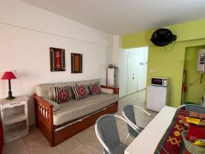 a living room with a couch and a table at DEPARTAMENTO PLAYA MIRAMAR in Miramar