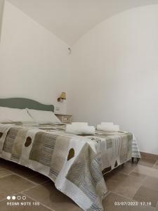 a bedroom with a bed with a blanket on it at Villa Confalonieri in Tricase