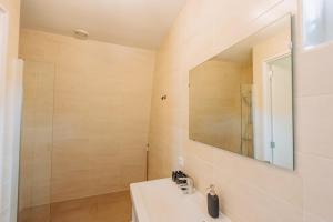 a bathroom with a sink and a mirror at Brand new bright luxurious villa in Amsterdam! in Amsterdam