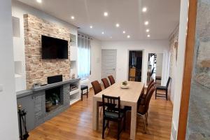 a dining room with a table and a fireplace at Bravaholidays-600-Mas Altaba in Terra Brava