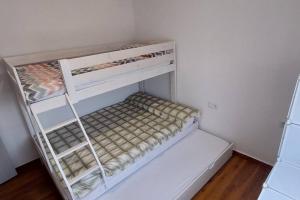 a white bunk bed in a small room at Bravaholidays-600-Mas Altaba in Terra Brava +33 photos