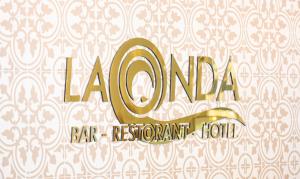 a gold bar restaurant sign on a wall at La Onda Hotel Durres in Durrës