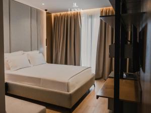 a hotel room with a bed and a window at La Onda Hotel Durres in Durrës