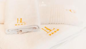 a white blanket with gold stars on it at La Onda Hotel Durres in Durrës