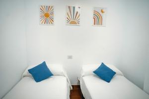 two white couches with blue pillows in a room at Bonito apartamento en primera línea de playa in Motril