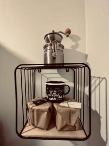a metal shelf with a coffee cup and a box at Maciejowiec Castle Hill Apartment I in Maciejowiec