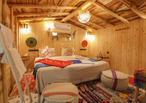a bedroom with a bed in a wooden room at Atlas Prestige in Imlil