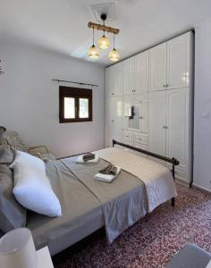 a bedroom with a bed with a tray on it at Cactus villa in Karpathos Town