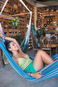 a woman is laying in a hammock at La Terraza Hostel in Flores