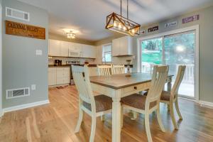 a kitchen and dining room with a wooden table and chairs at Charming Ohio Retreat with Deck, Porch and Gas Grill! in Howard